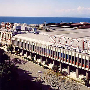 Photograph of a factory or plant with a "Coca Cola" sign 