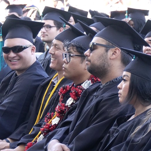 Students in caps and gowns sit for commencement at Honolulu Community College. Image from University of Hawai‘i News