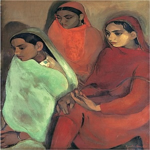 Three girls sitting with gazes cast downward. Each wearing a different-colored sari. The girl on the left is wearing light green, the girl in the middle is in orange, and the girl on the right is in red. 