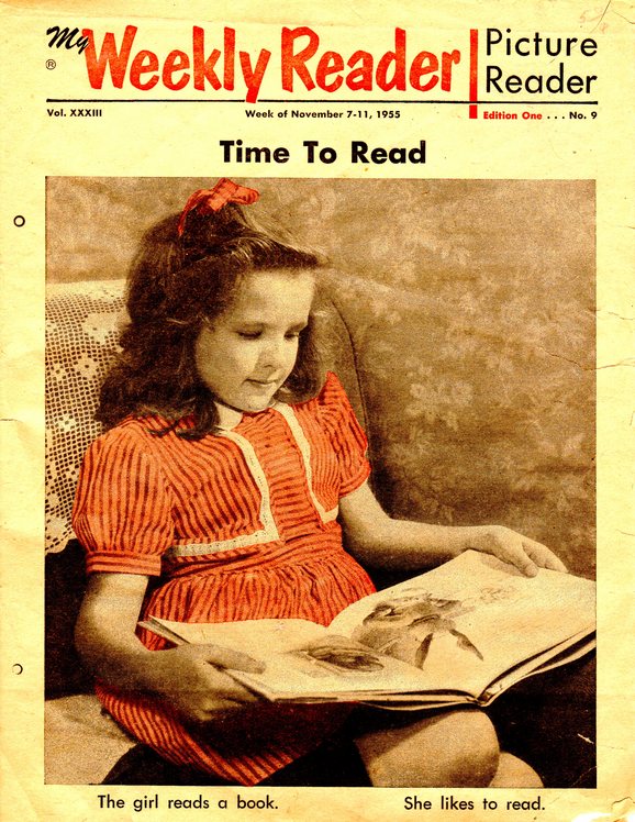 Magazine cover of young girl reading book