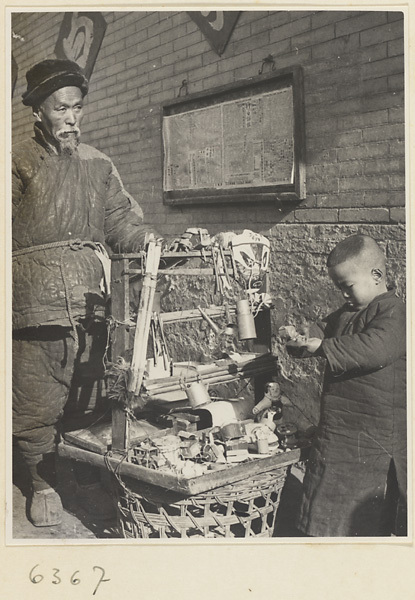 Man and boy standing with toys to be sold