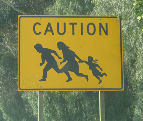 Immigrant Crossing Road Sign