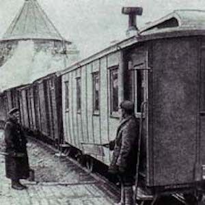 Black and white photograph of train standing at station