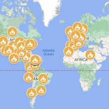 A world map with orange markers placed at the site of protests from social media. 