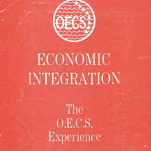 The red cover of the treaty, which reads "Economic Integration: The O.E.C.S. Experience." The top center has a circular symbol with triangles and waves that reads "OECS." In the bottom left it reads "Organisation of Eastern Caribbean States (OECS) Central Secretariat St. Lucia March 1988." 