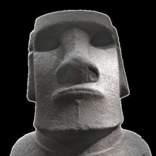 A moai head with distinctively large nose and lips, rectangular ears, and a large forehead. 