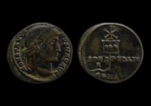 Front and back of aged coins. One side has a side profile of a person and the other has an insignia.