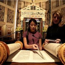 Thumbnail of girl reading from Torah