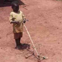 Thumbnail of a boy playing with a toy truck