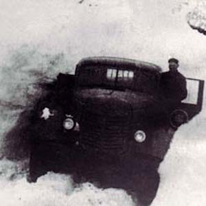 Black and white photograph of a truck in snow